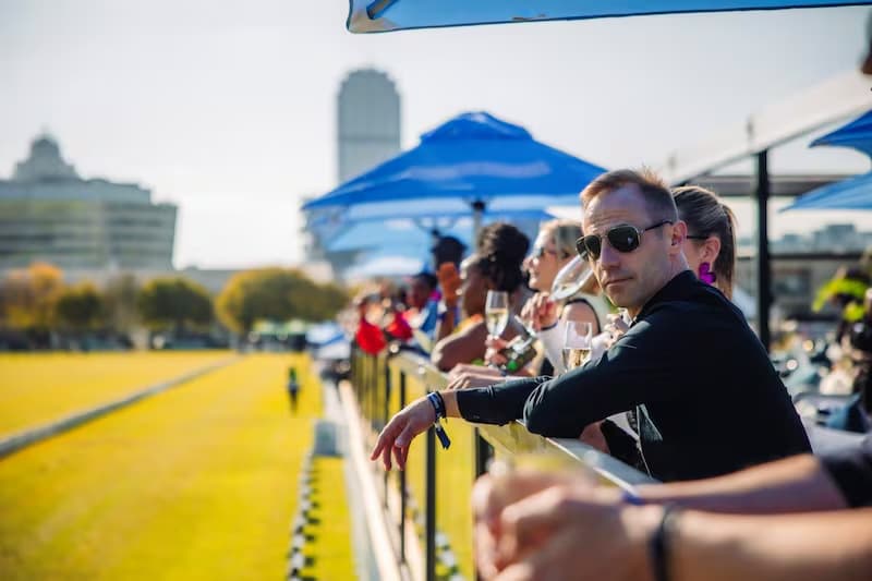 Guests enjoying a picnic and butler service at the American Express Café overlooking the field at the Nedbank International Polo