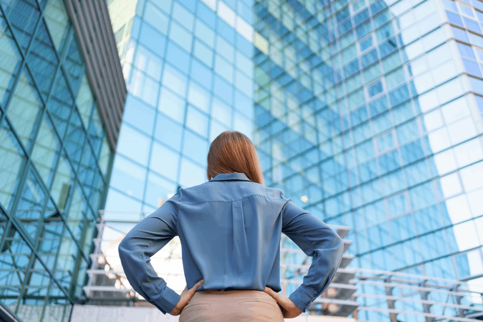 A professional standing in front of glass office towers, illustrating in-demand career paths in 2026