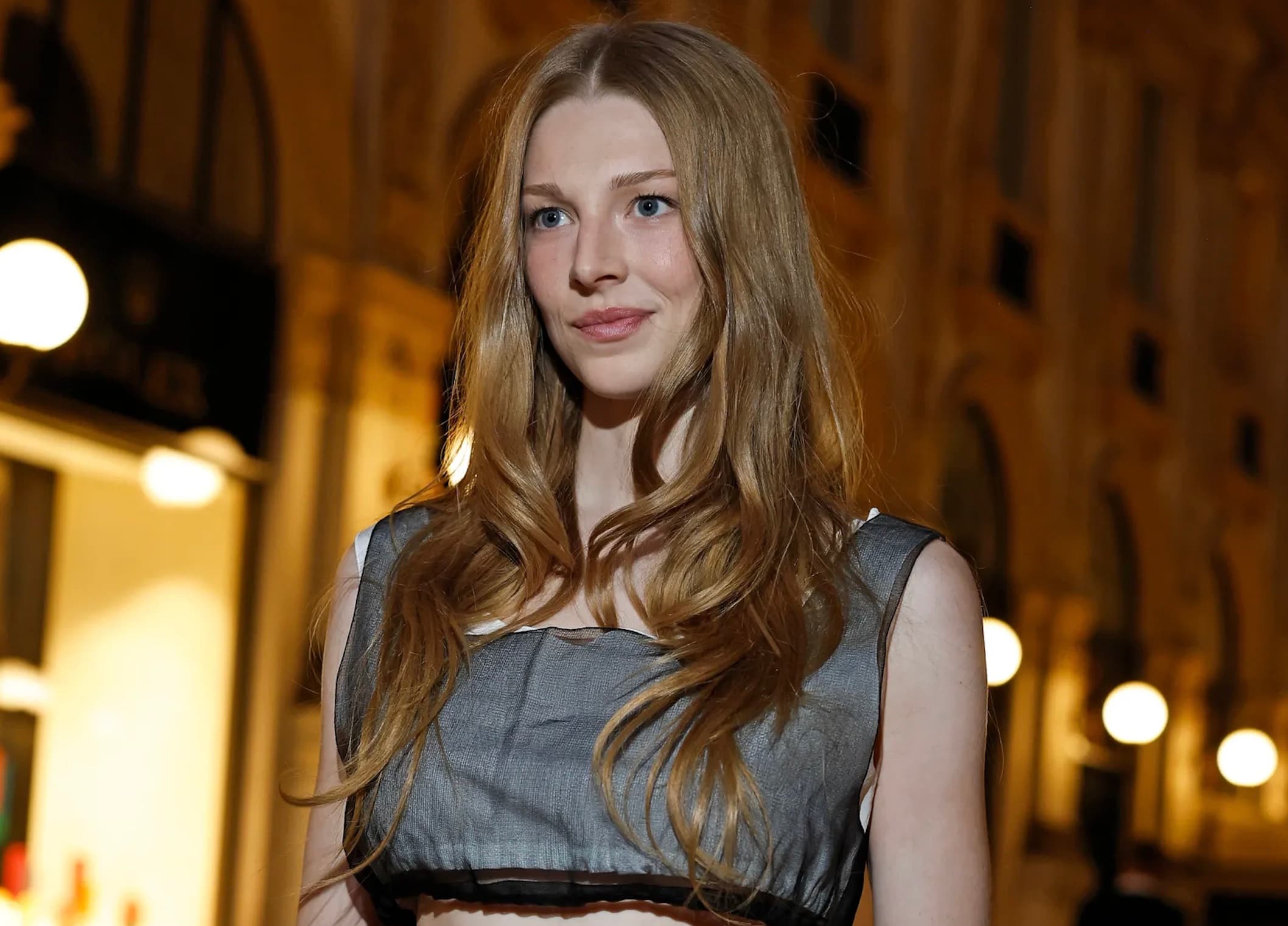 Hunter Schafer in a sheer gray and black Prada top at Vogue World Milano