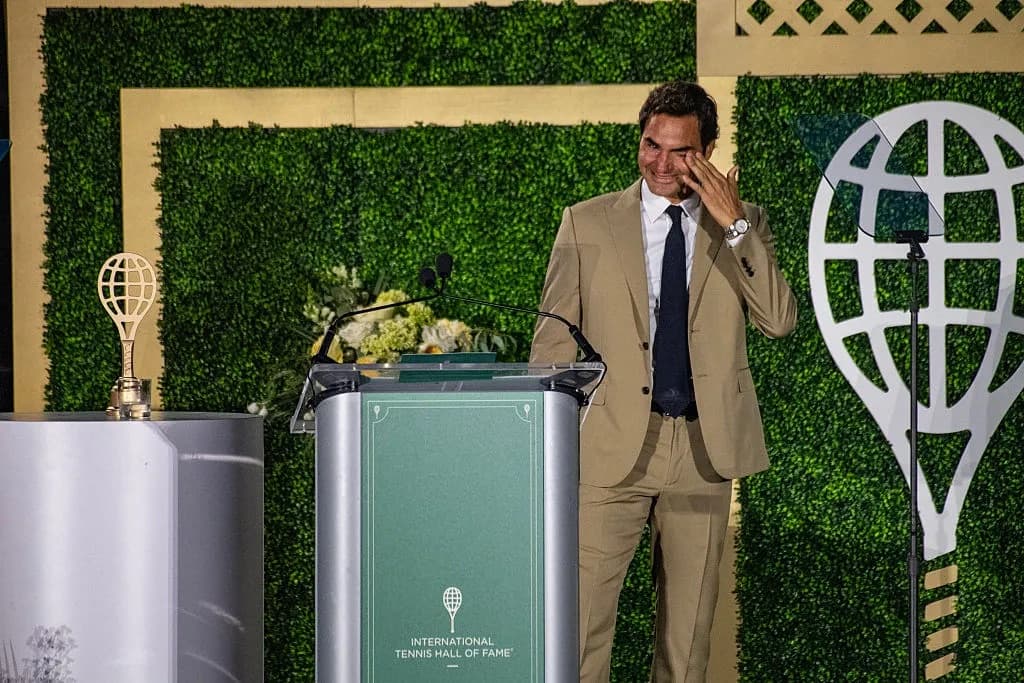 Roger Federer wiping tears while speaking at a podium during his Tennis Hall of Fame induction
