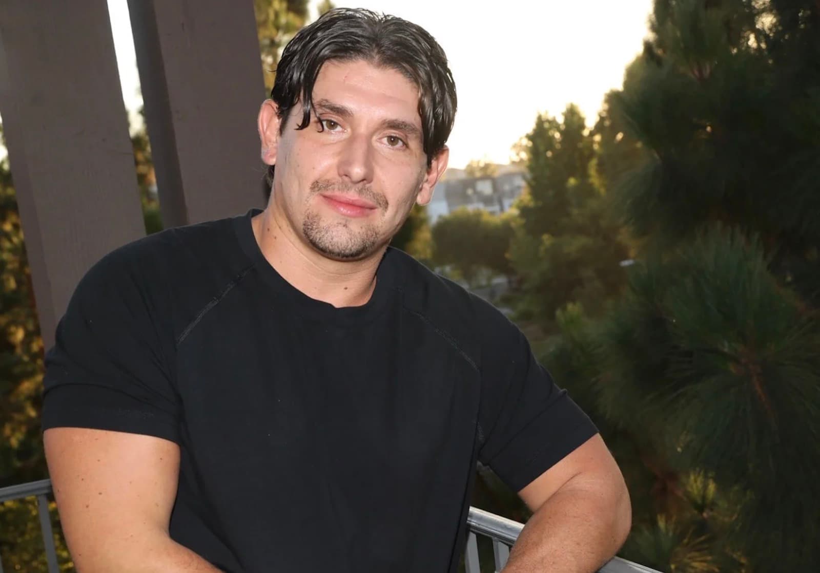 Entrepreneur and investor Alexander Spellane wearing a gold watch on a balcony at dusk