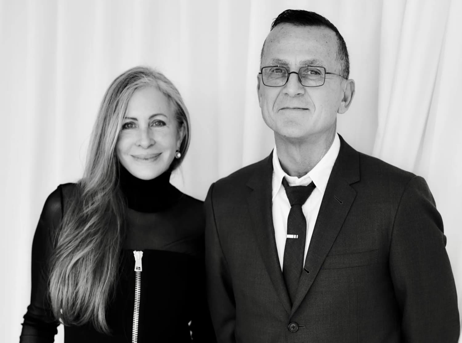 Carmen Busquets photographed in black and white alongside a colleague against a pale backdrop