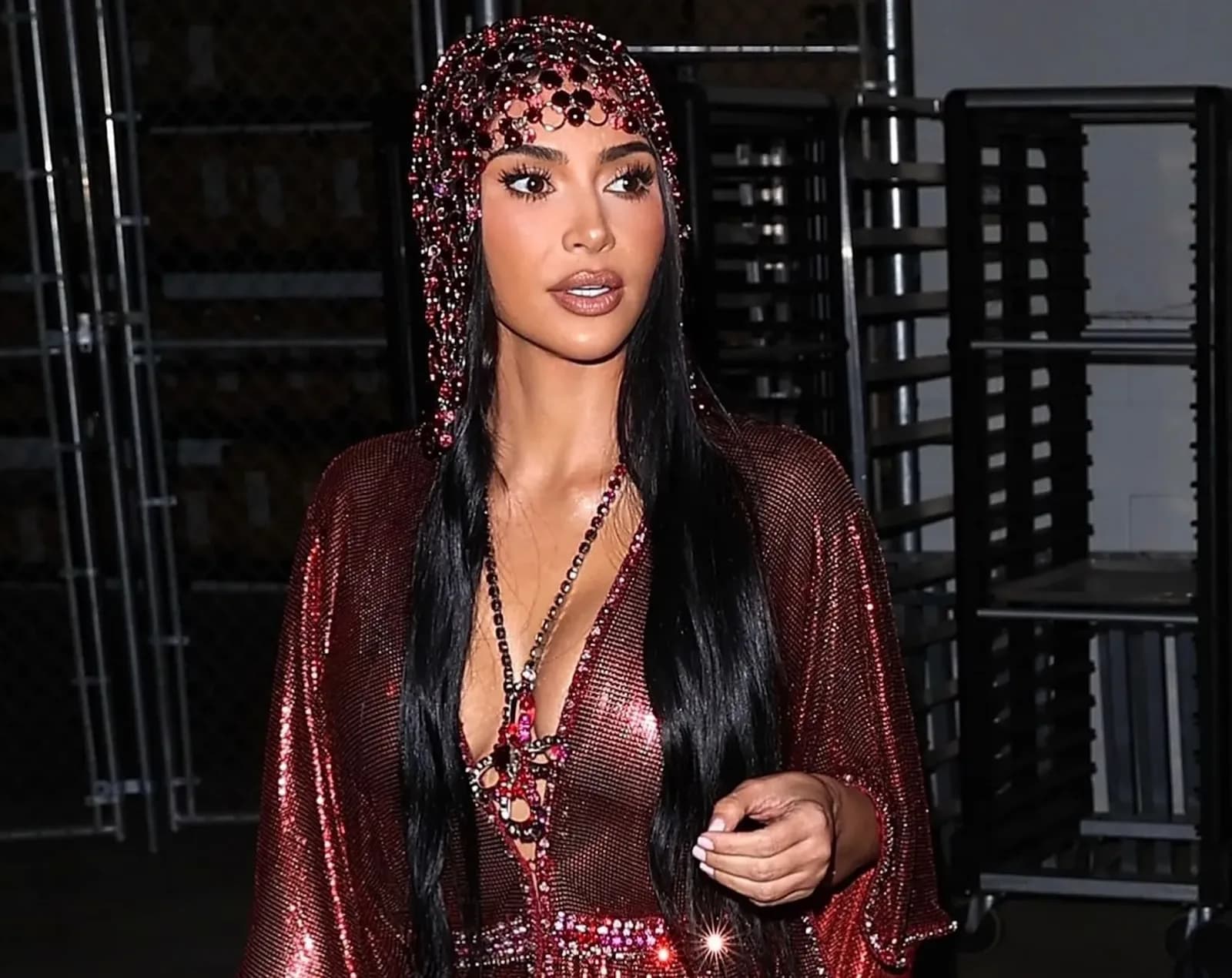 Kim Kardashian wearing a fuchsia metal mesh dress and jeweled headpiece