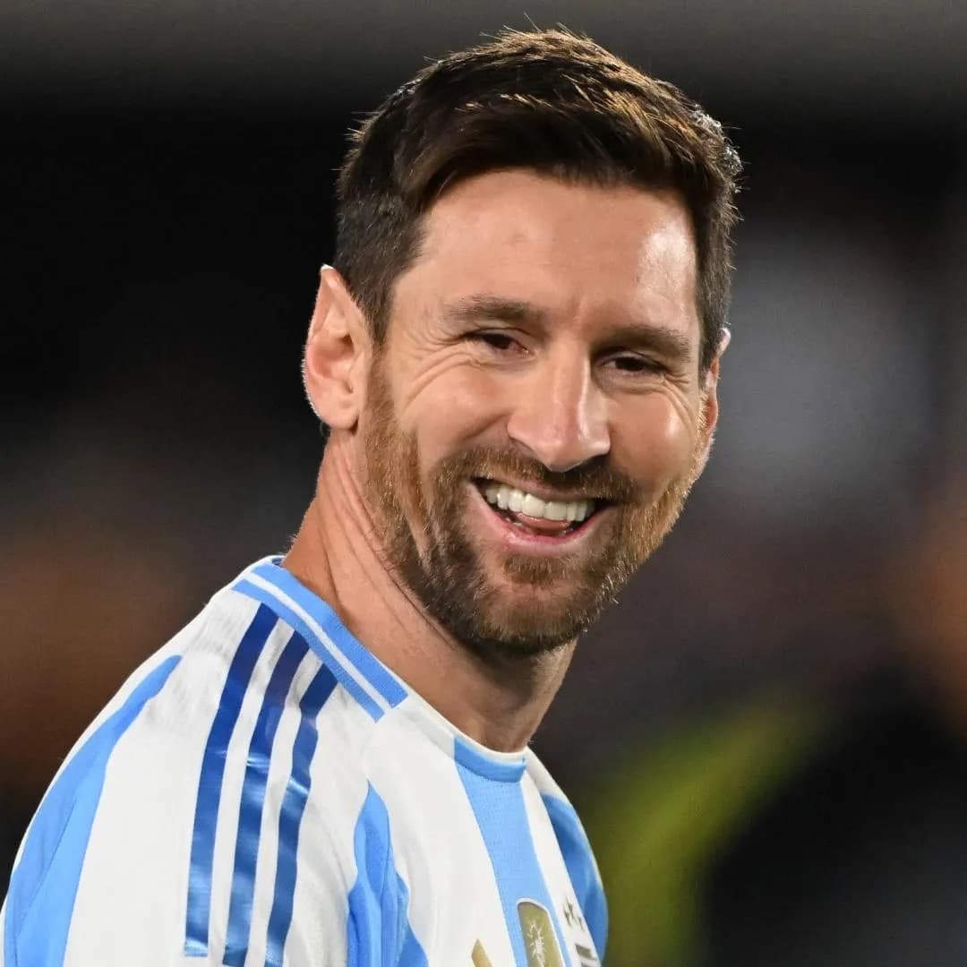 Lionel Messi smiling in an Argentina jersey during a match