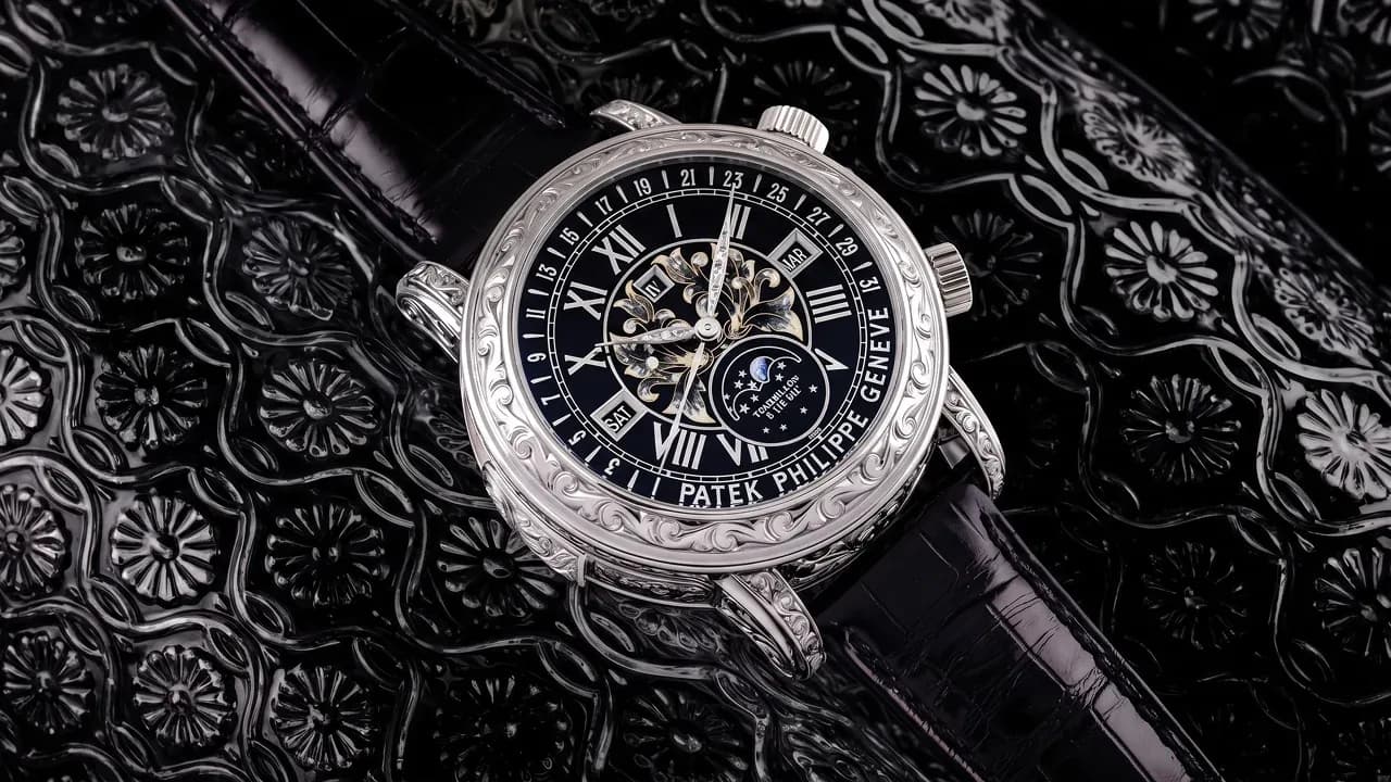A Patek Philippe Sky Moon Tourbillon watch with an engraved white gold case on a black strap